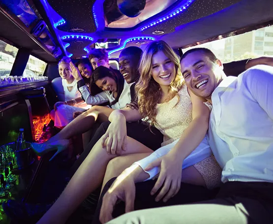 Friends having fun in a cool Limousine with colorful lights inside.