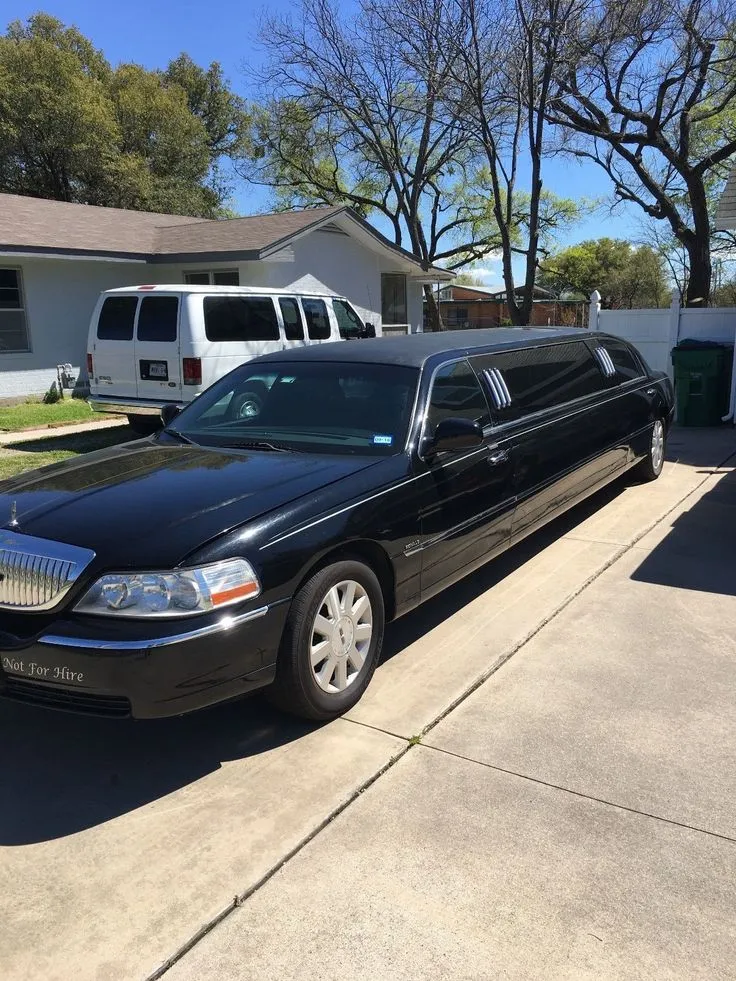 Black limousine parked outside, great for stylish transportation and special events.