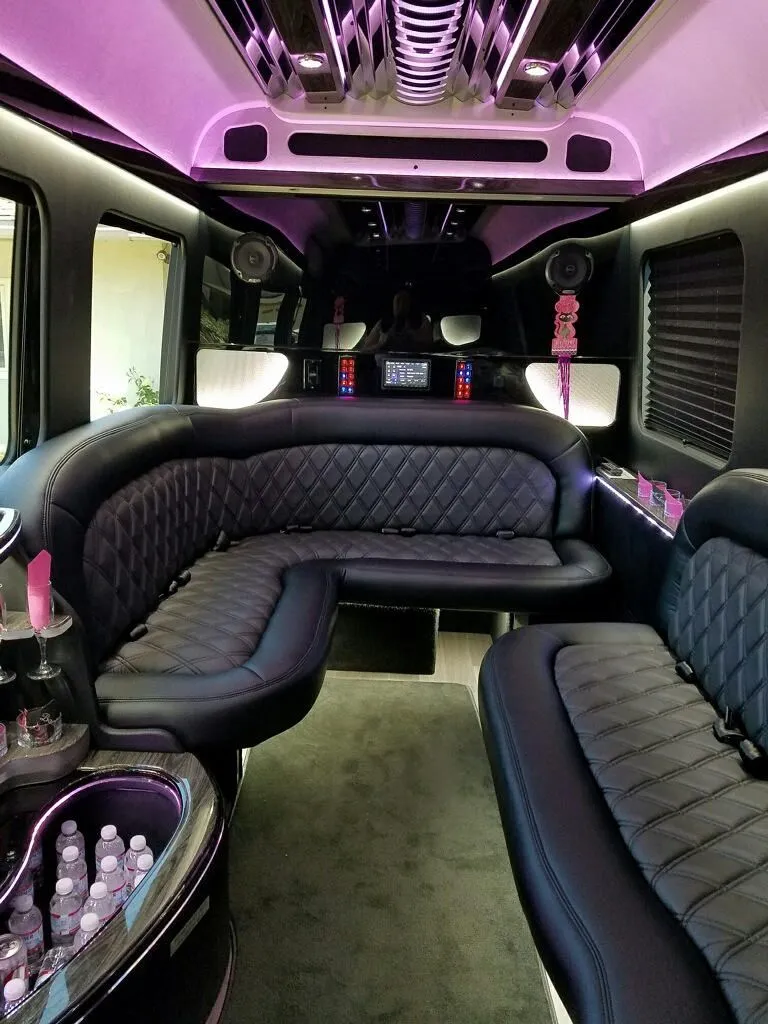 Inside of a fancy limo for fun event transportation, featuring comfy seats and lights.